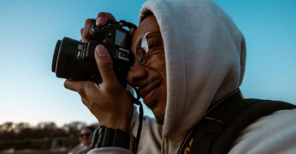 Man Taking Photo With Nikon Camera