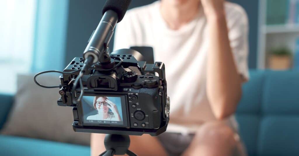 Woman In Glasses Recording A Video With A Sony Camera