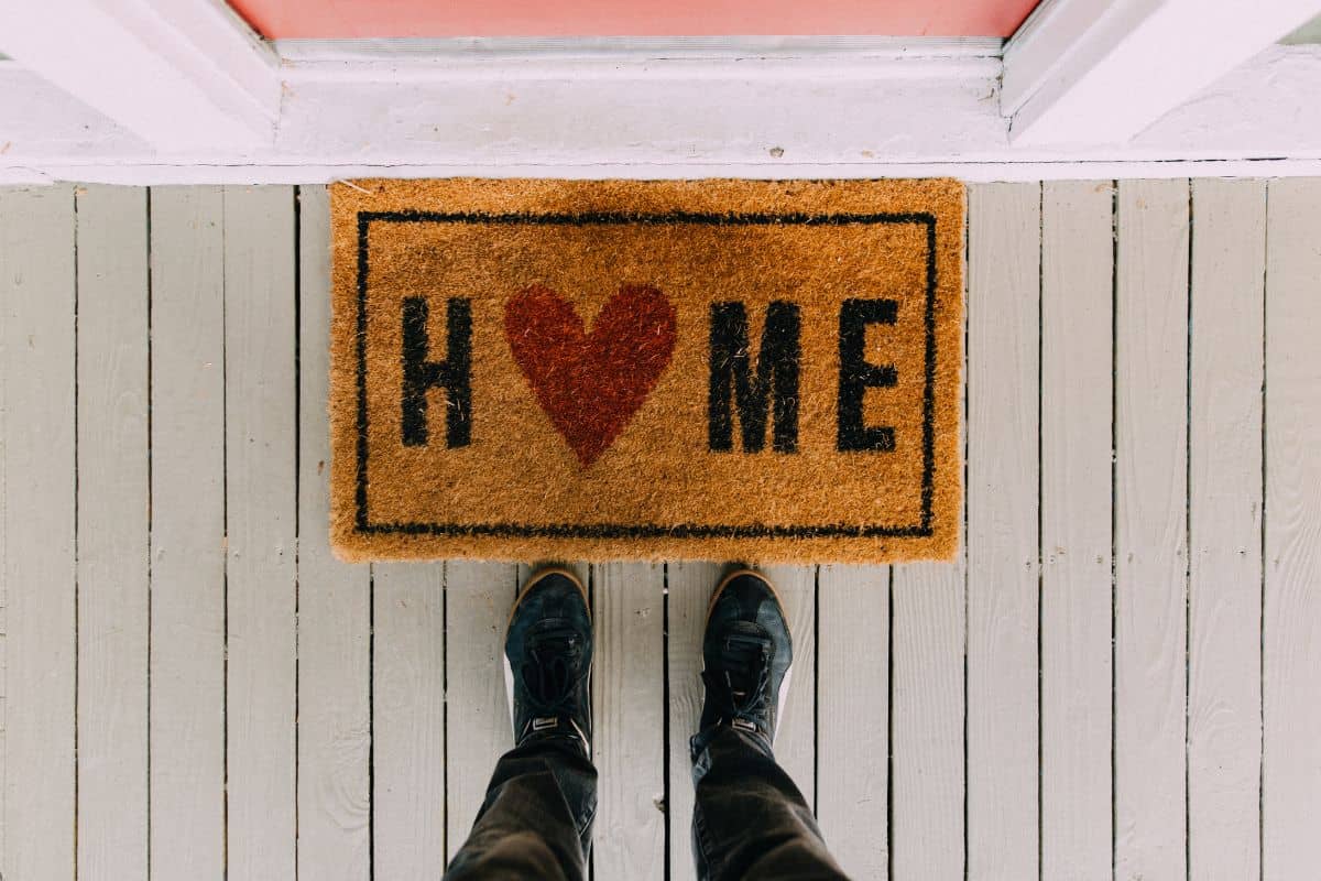 a home footmat with mens shoes